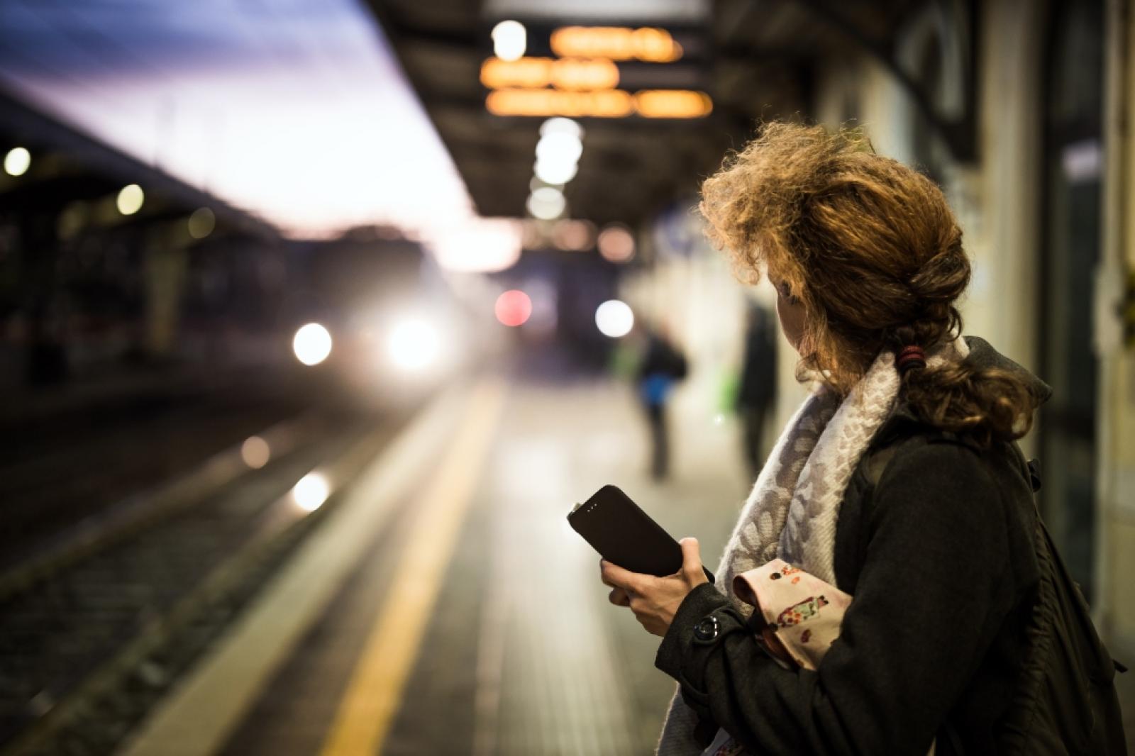 Woman at train station at night