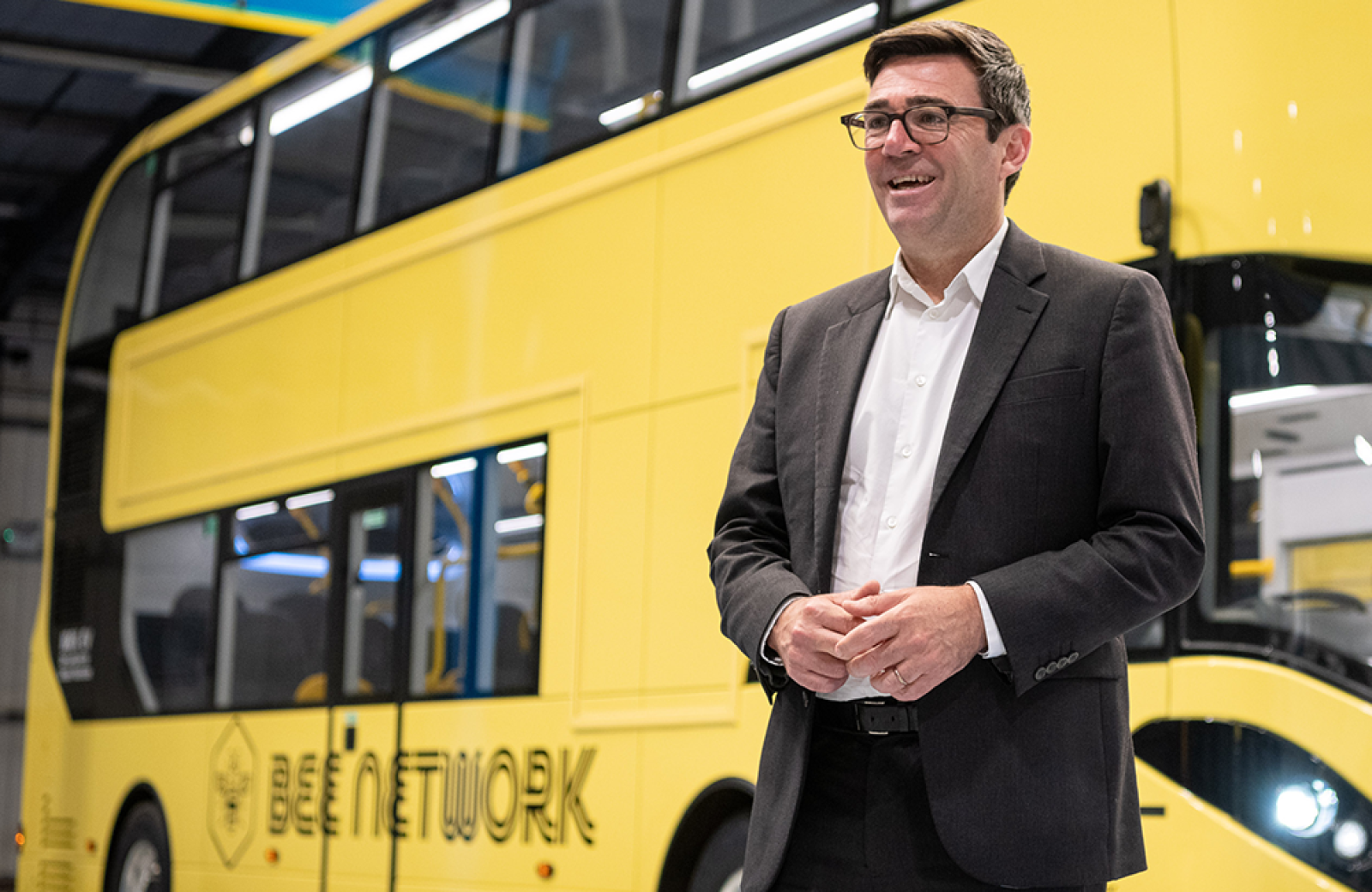 Andy Burnham by a bus