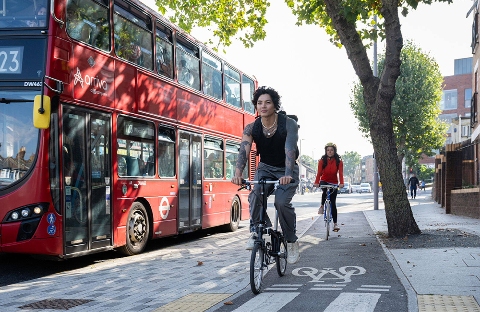 People cycling alongside a bus in London