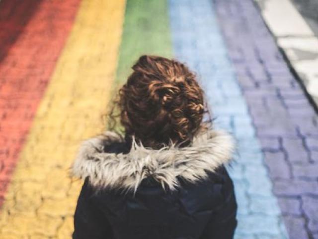 Child on rainbow cobbles