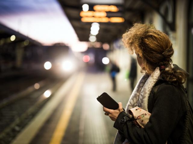 Woman at train station at night