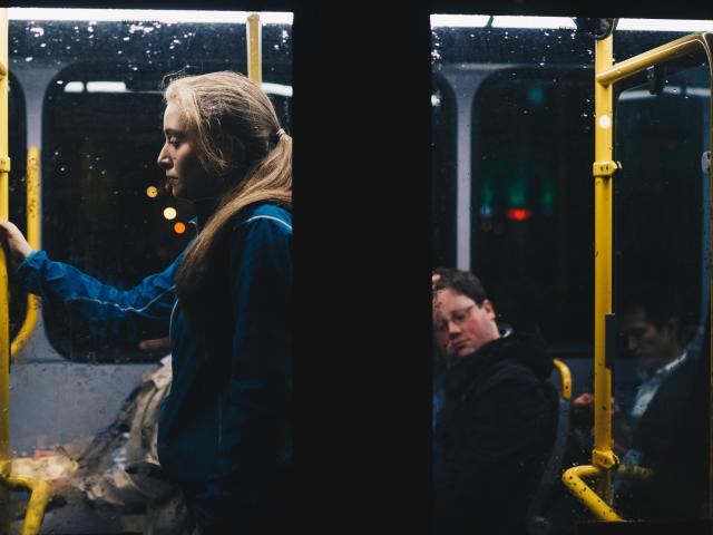 Woman standing on bus