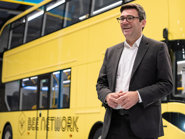 Andy Burnham by a bus