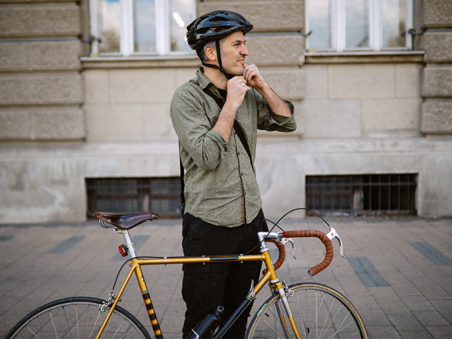 A man getting ready to ride a bike